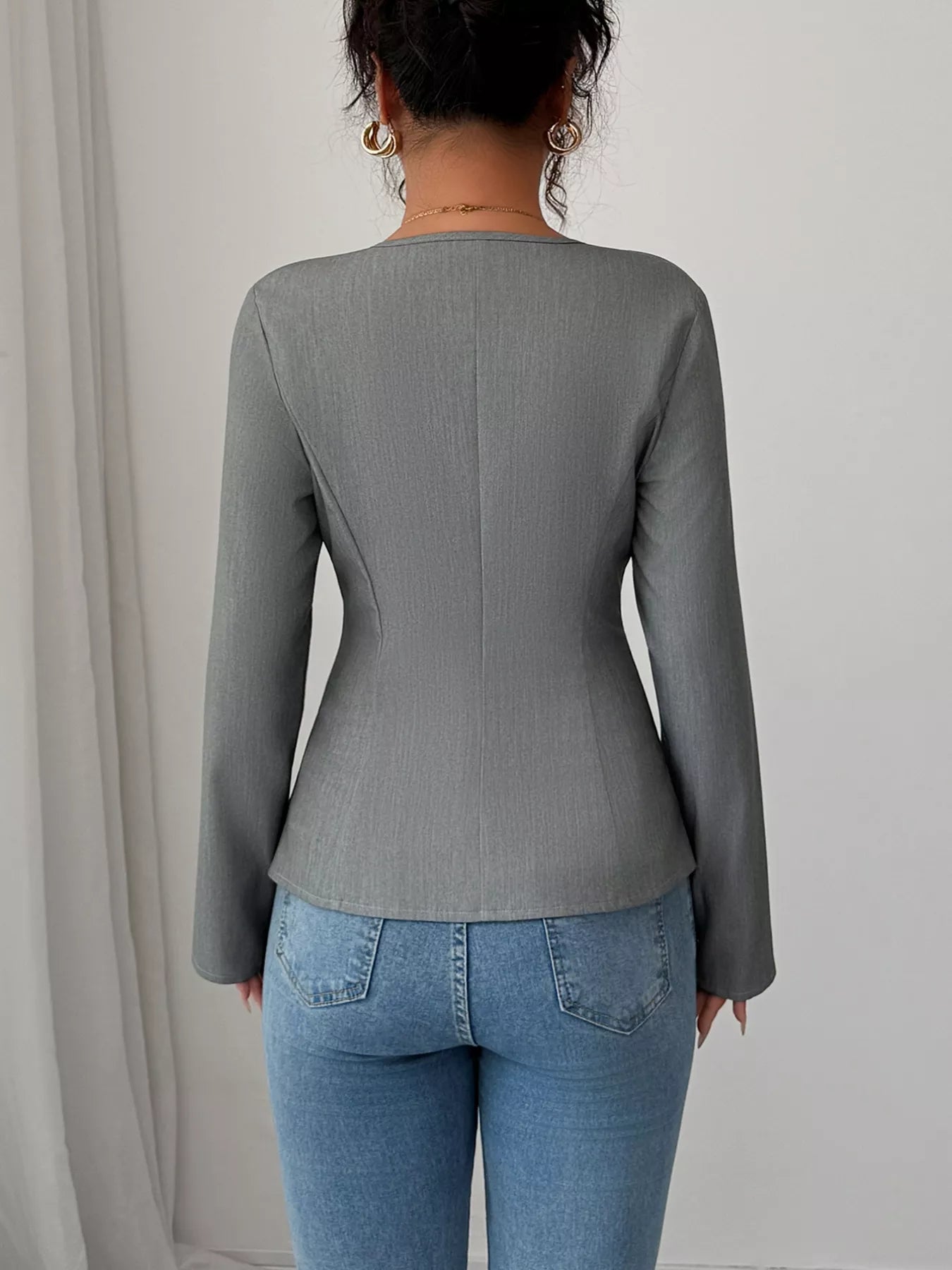Back view of flower button blazer with long sleeves