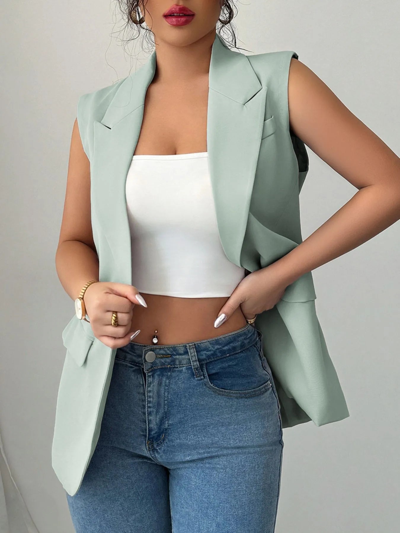 One Button Sleeveless Blazer in light green worn over a white crop top, styled with high-waisted jeans.