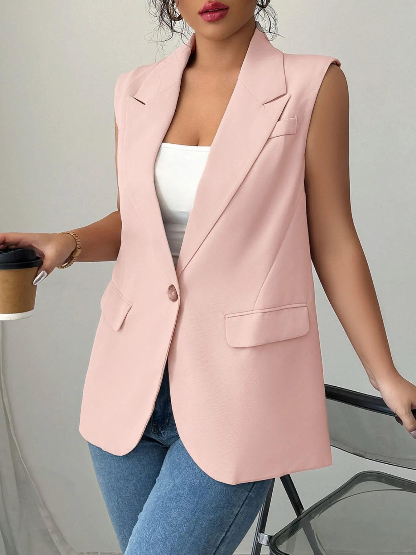 One Button Sleeveless Blazer in light pink, styled with a white top and blue jeans, perfect for a chic, modern look.