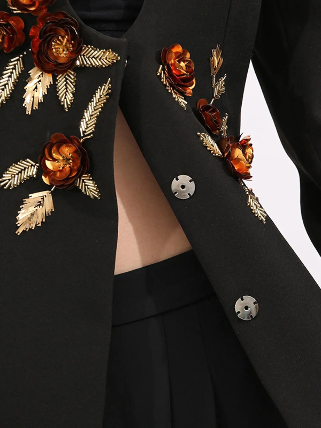 Model wearing embroidered long sleeve blazer