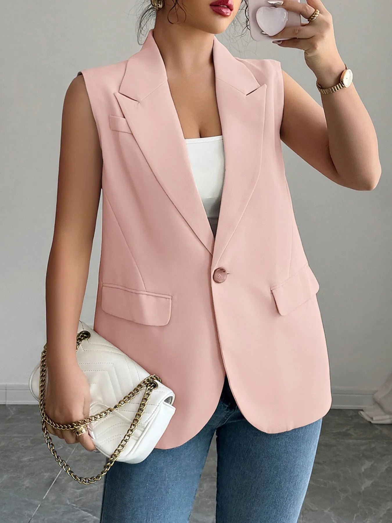 One Button Sleeveless Blazer in soft pink color, showcasing a stylish sleeveless design, perfect for a chic outfit.